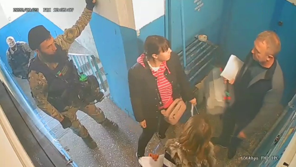 Screenshot from a video posted by witnesses of a so-called ’mobile electoral commission’ accompanied by armed Russians