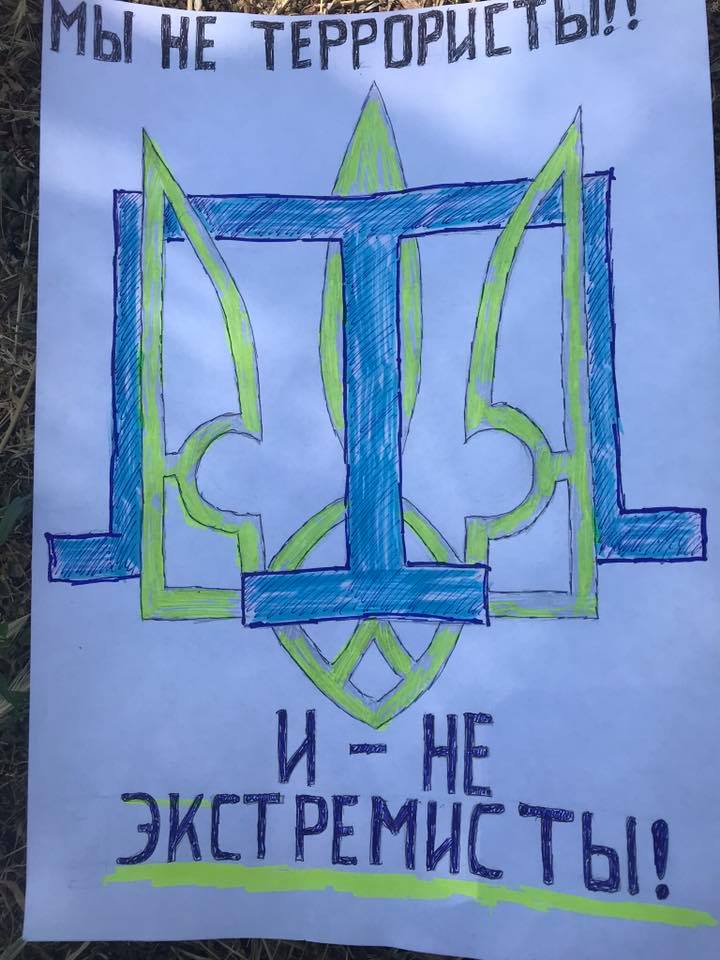 Ismael Ramazanov’s image with the Crimean Tatar Tamga and Ukrainian trizub. The words read We are not terrorists, nor extremists